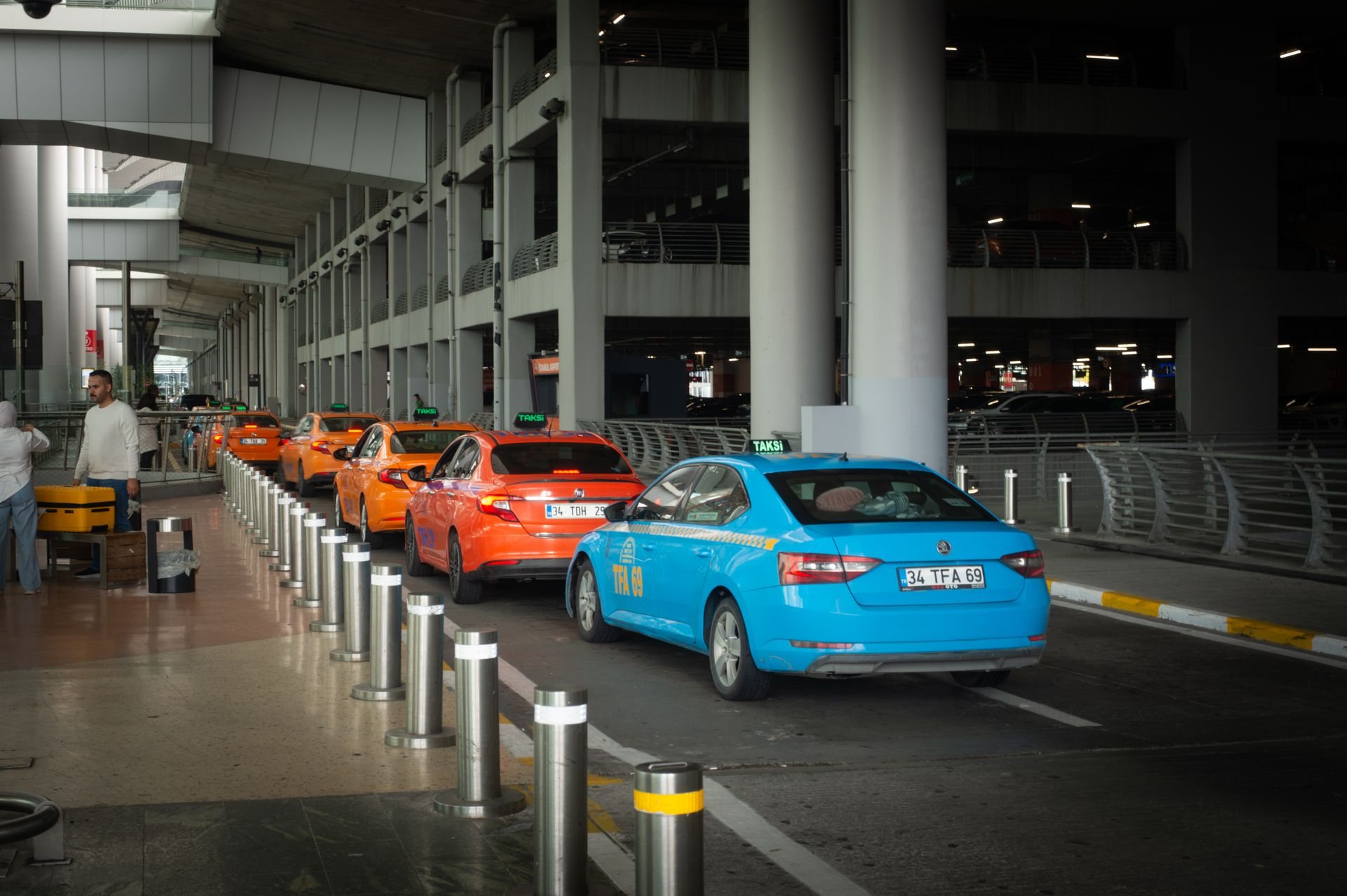 Taxis waiting in line at an airport curb