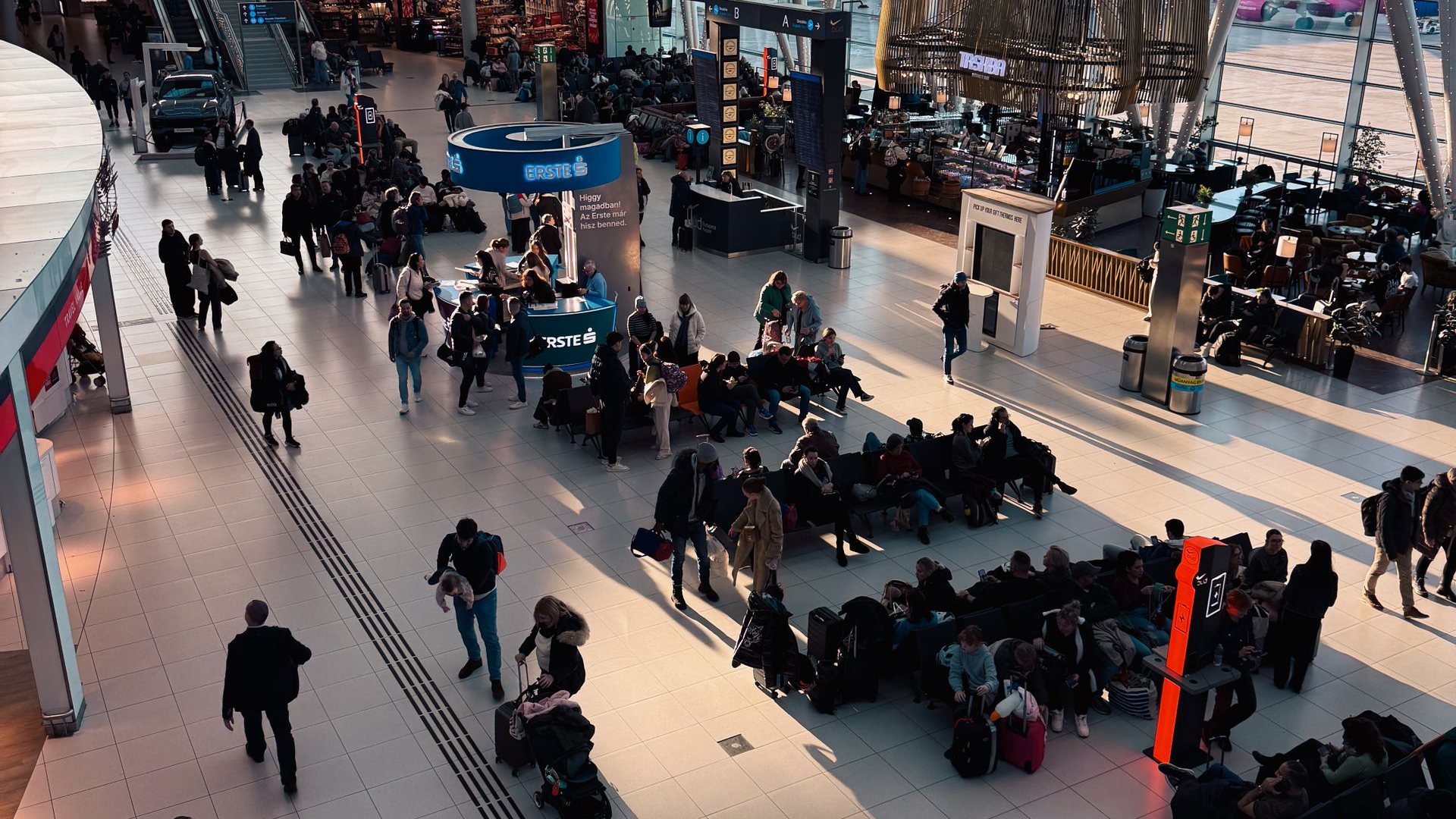 Overhead view of passengers moving through an airport terminal